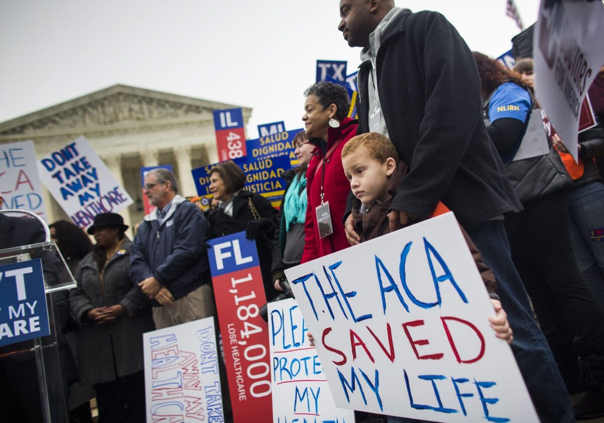 Supporters of the Affordable Care Act stand outside the Supreme Court during a rally held prior to the high court's hearing a second major challenge to the law earlier this month.
