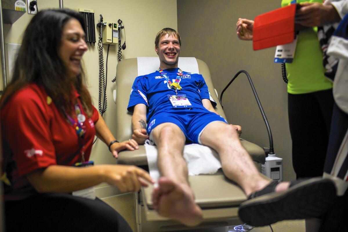 Dr. Lynne McCullough examines Special Olympics athlete Jakob Larusson, 25, of Iceland at the UCLA Arthur Ashe Student Health and Wellness Center.