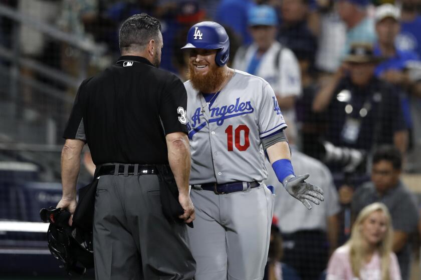Los Angeles Dodgers' Justin Turner, right, argues with home plate umpire Rob Drake after striking out to end the baseball game against the San Diego Padres, Monday, Aug. 26, 2019, in San Diego. The Padres won 4-3. (AP Photo/Gregory Bull)