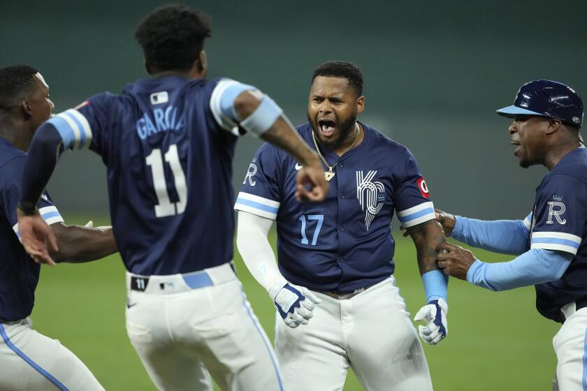 Kansas City Royals' Nelson Velazquez (17) celebrates with Maikel Garcia (11) after their baseball game against the Seattle Mariners Friday, June 7, 2024, in Kansas City, Mo. The Royals won 10-9. (AP Photo/Charlie Riedel)
