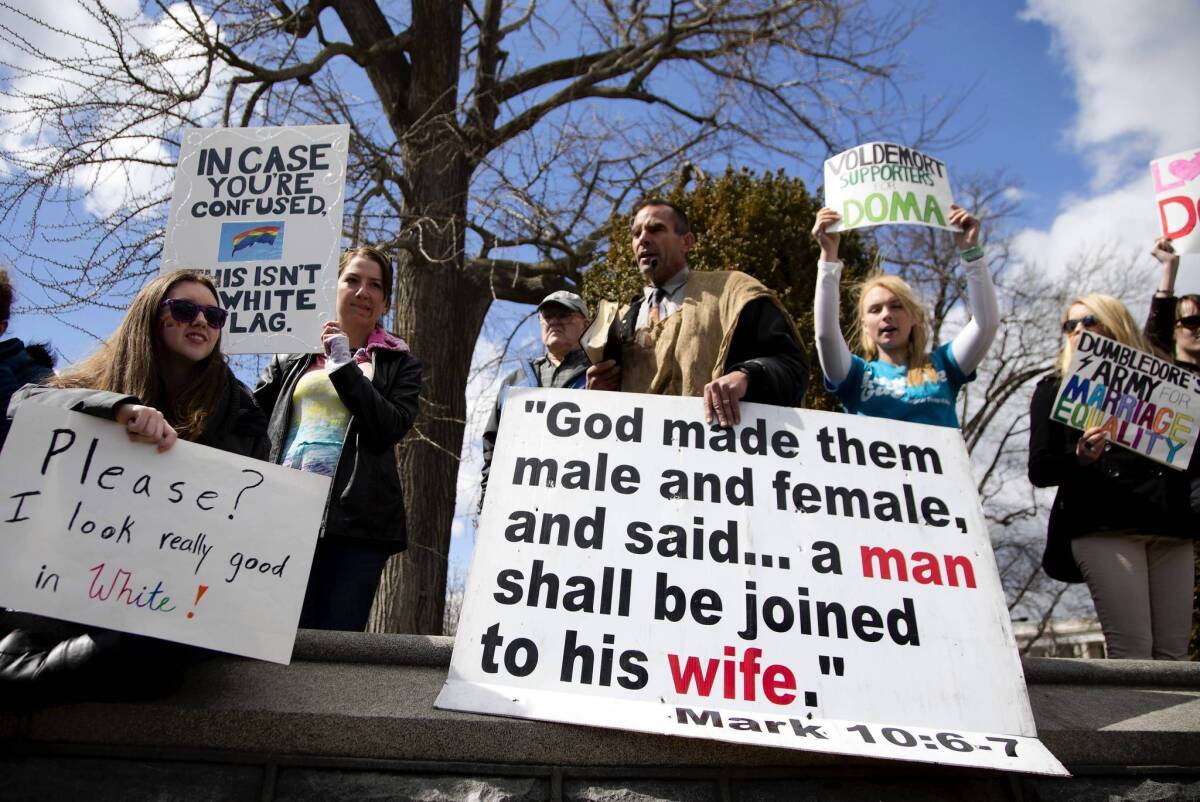 Protesters demonstrate outside the Supreme Court on March 27 after the justices heard oral arguments in the Defense of Marriage case.