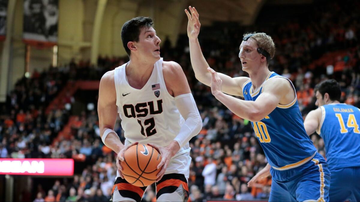 Oregon State's Drew Eubanks is defended by UCLA's Thomas Welsh during a recent game.