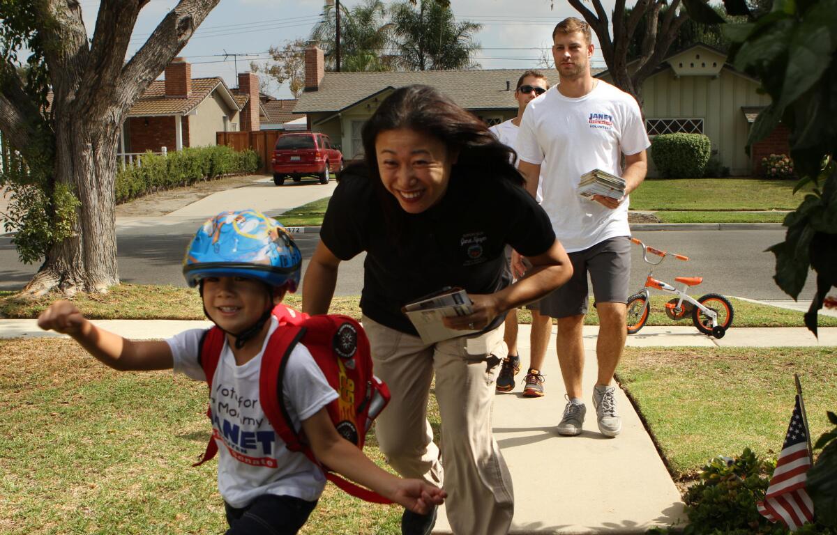 Janet Nguyen, shown going door-to-door while campaigning, won a key state Senate race that prevented the Democrats from regaining a supermajority in the state Senate.