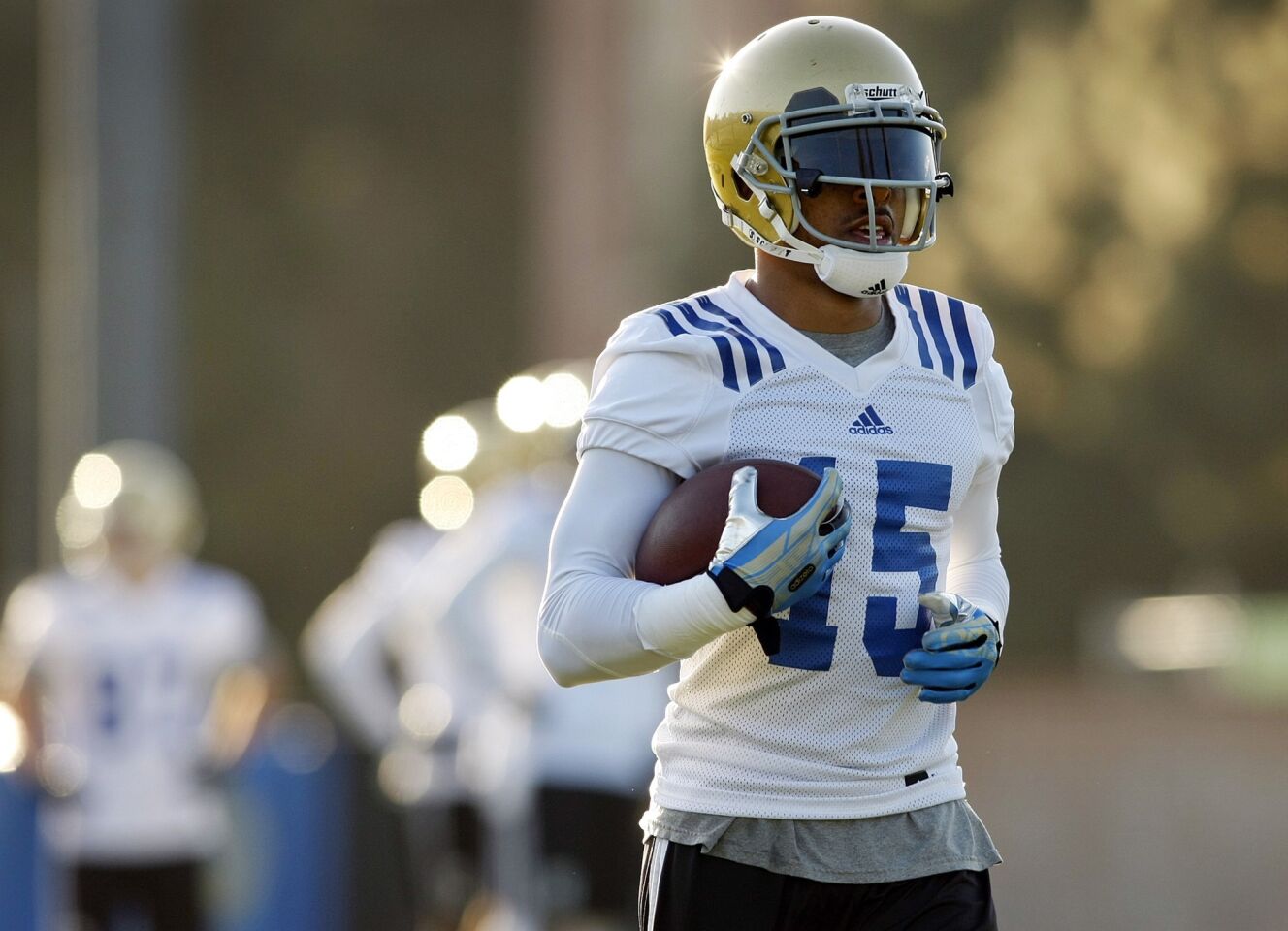UCLA wide receiver Devin Lucien catches passes Tuesday morning during the Bruins' first spring practice.