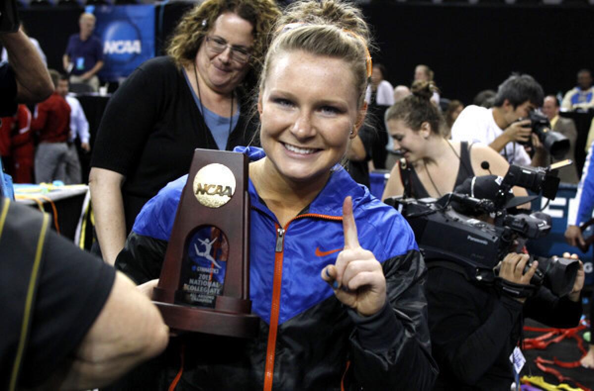 Florida's Bridget Sloan gives the No. 1 sign after winning all-around gymnast at the NCAA championships on Sunday at Pauley Pavilion.
