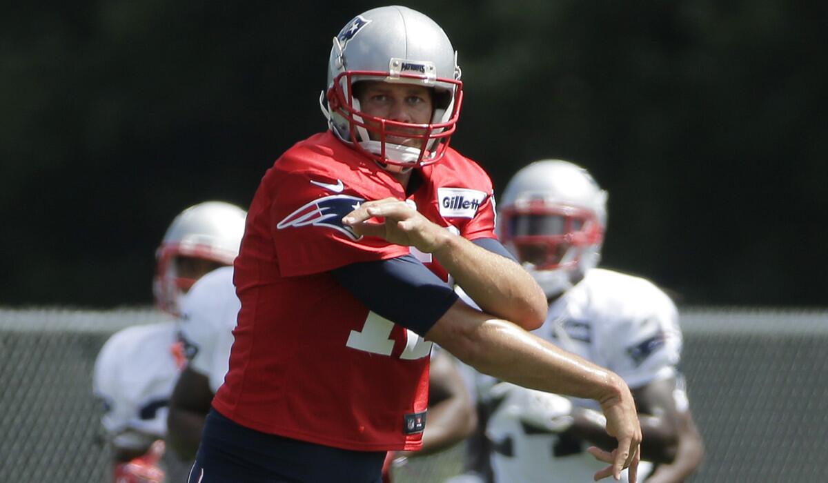 New England Patriots quarterback Tom Brady follows through on a pass during training camp practice with the Chicago Bears on Aug. 15.