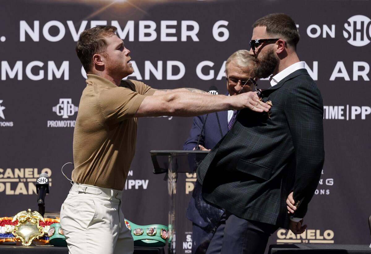 Unified WBC/WBO/WBA super middleweight champion Canelo Alvarez shoves undefeated IBF Super Middleweight Champion Caleb Plant 