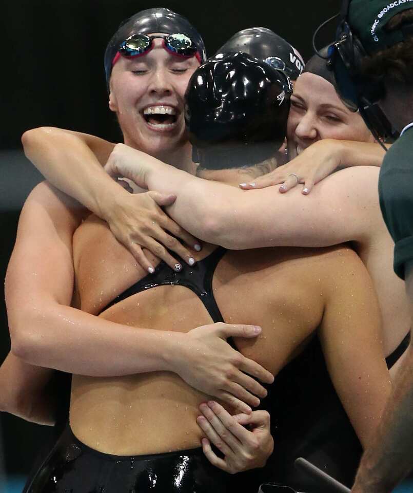 Shannon Vreeland, left, Missy Franklin, Dana Vollmer and Allison Schmitt embrace after winning the gold medal in the women's 4x200 freestyle relay.