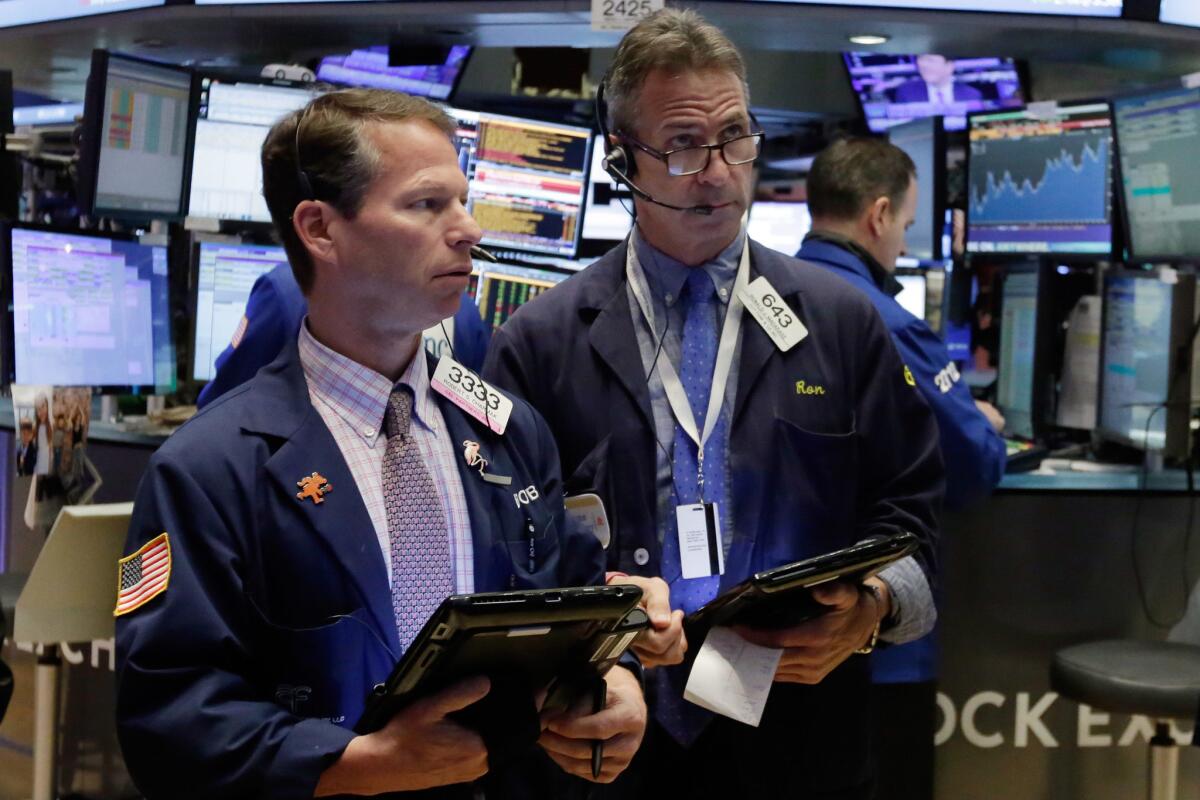 Traders work on the floor of the New York Stock Exchange on March 16.