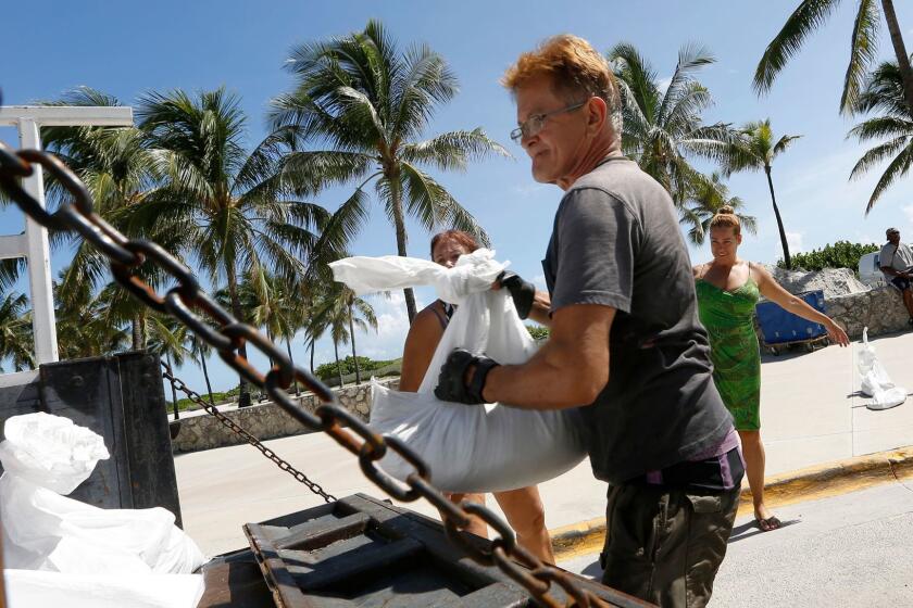 MIAMI, FLORIDA--SEPT. 7, 2017--Genaro Dacosta, age 65, of Miami Beach loads sandbags. He says he can't evacuate because he has a monkey. Preparations are underway for Hurricane Irma, as it makes its way towards Florida. (Carolyn Cole/Los Angeles Times)