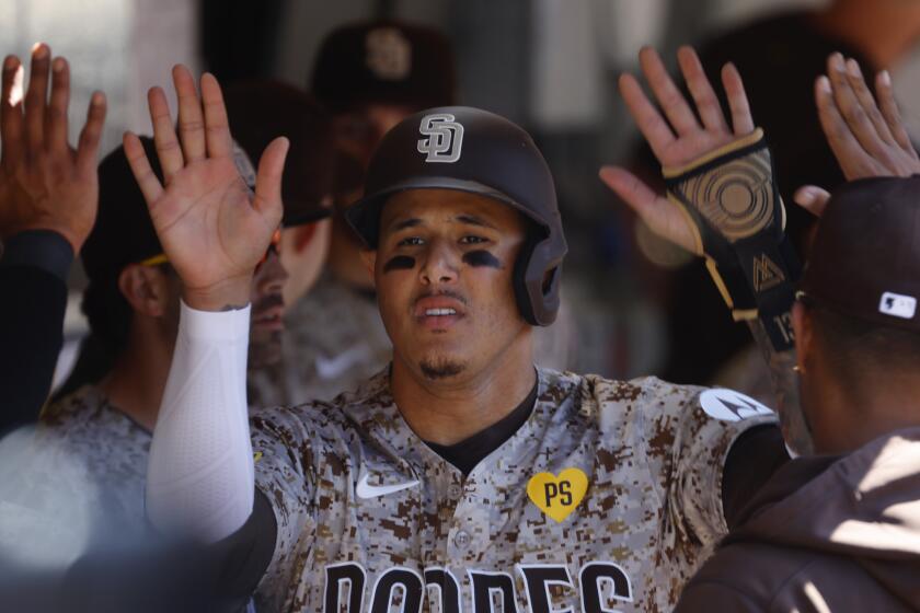 San Diego, CA - May 26: San Diego Padres' Manny Machado celebrates in the dugout after scoring on a bunt by Ha-Seong in the sixth inning against the New York Yankees at Petco Park on Wednesday, May 26, 2024. (K.C. Alfred / The San Diego Union-Tribune)