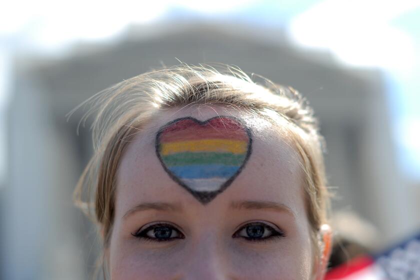 A same-sex marriage supporter has her forehead painted with rainbow colors as she joins demonstrations in front of the Supreme Court on March 27, 2013, in Washington, D.C.