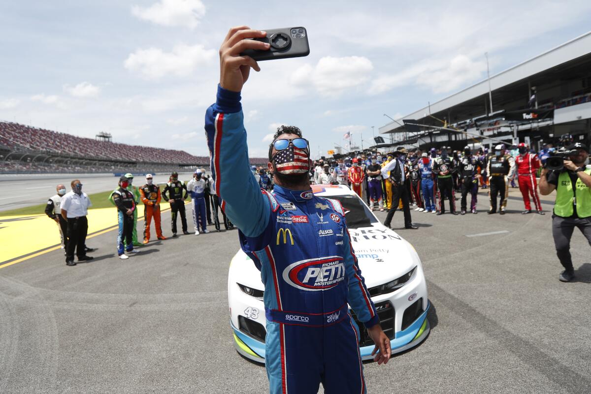 Bubba Wallace takes a selfie with himself and other drivers that pushed his car to the front in the pits on Monday.