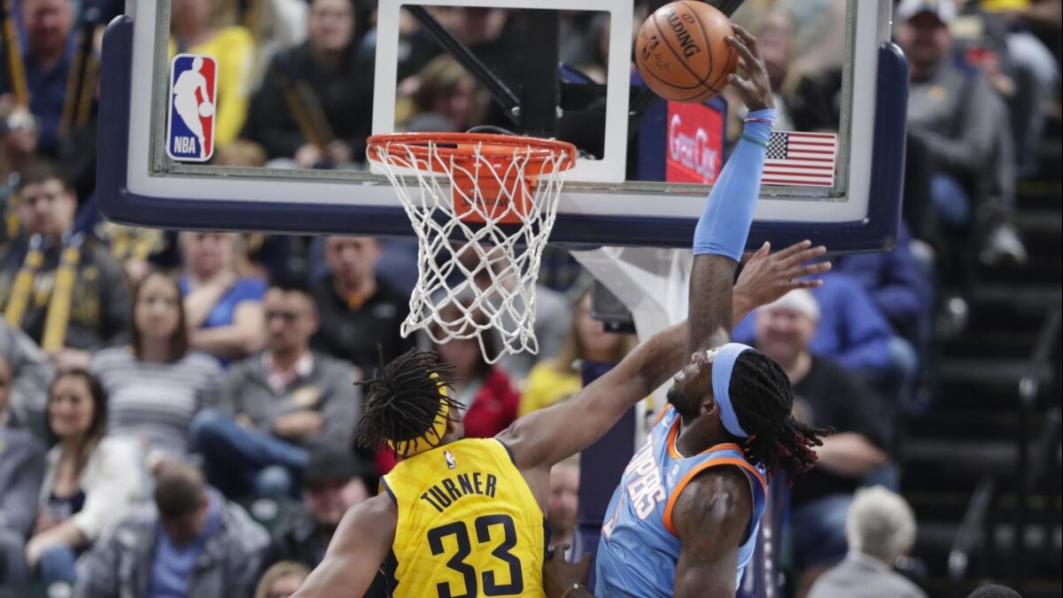 Clippers forward Montrezl Harrell is fouled by Pacers center Myles Turner on a dunk attempt Friday night.