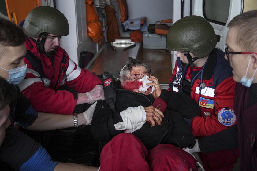 Ambulance paramedics move a wounded in shelling civilian onto a stretcher to a maternity hospital converted into a medical ward in Mariupol, Ukraine, Wednesday, March 2, 2022. Russian forces have seized a strategic Ukrainian seaport and besieged another. Those moves are part of efforts to cut the country off from its coastline even as Moscow said Thursday it was ready for talks to end the fighting. (AP Photo/Evgeniy Maloletka)