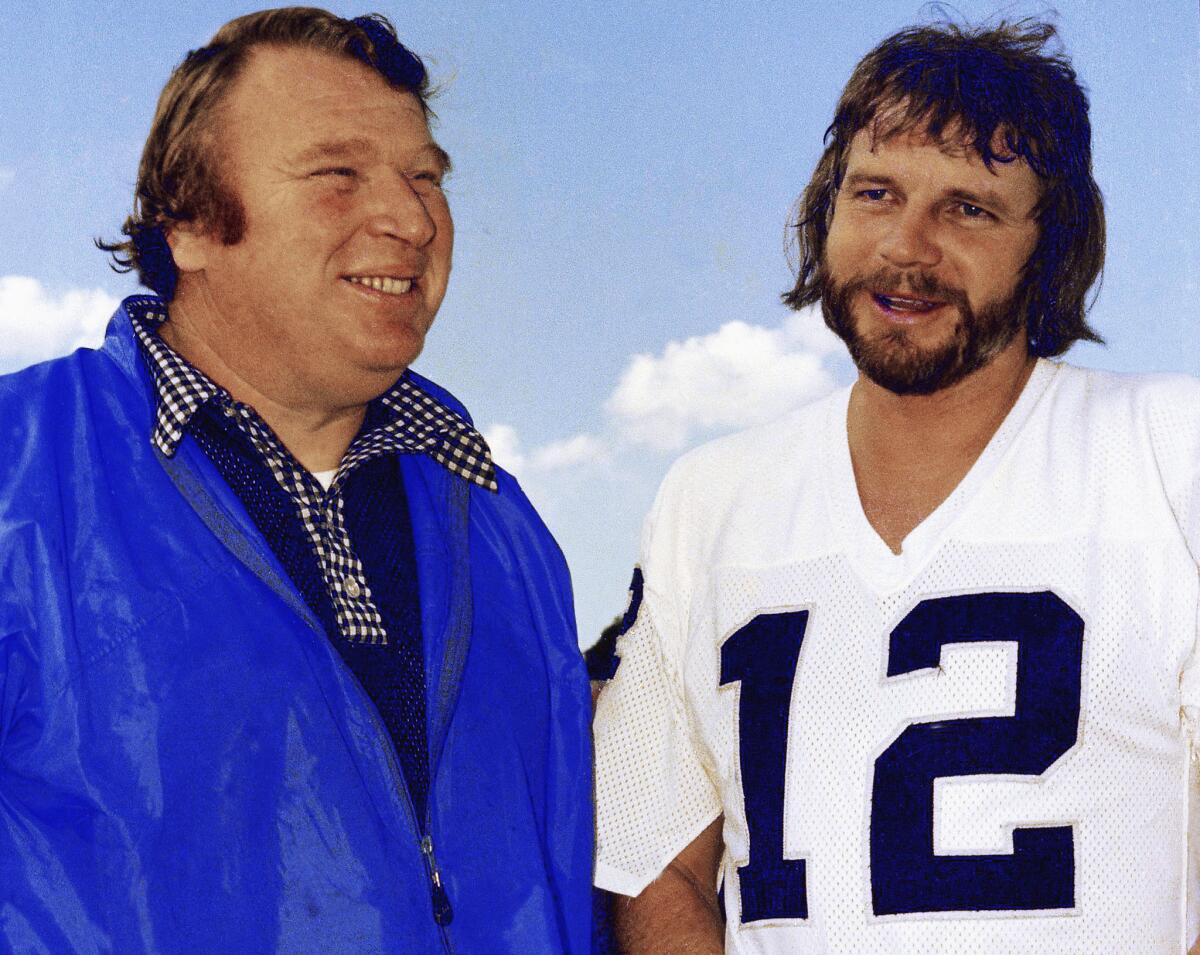 Raiders quarterback Ken Stabler, right, talks with Coach John Madden in Oakland, Calif. on Jan. 4, 1977.