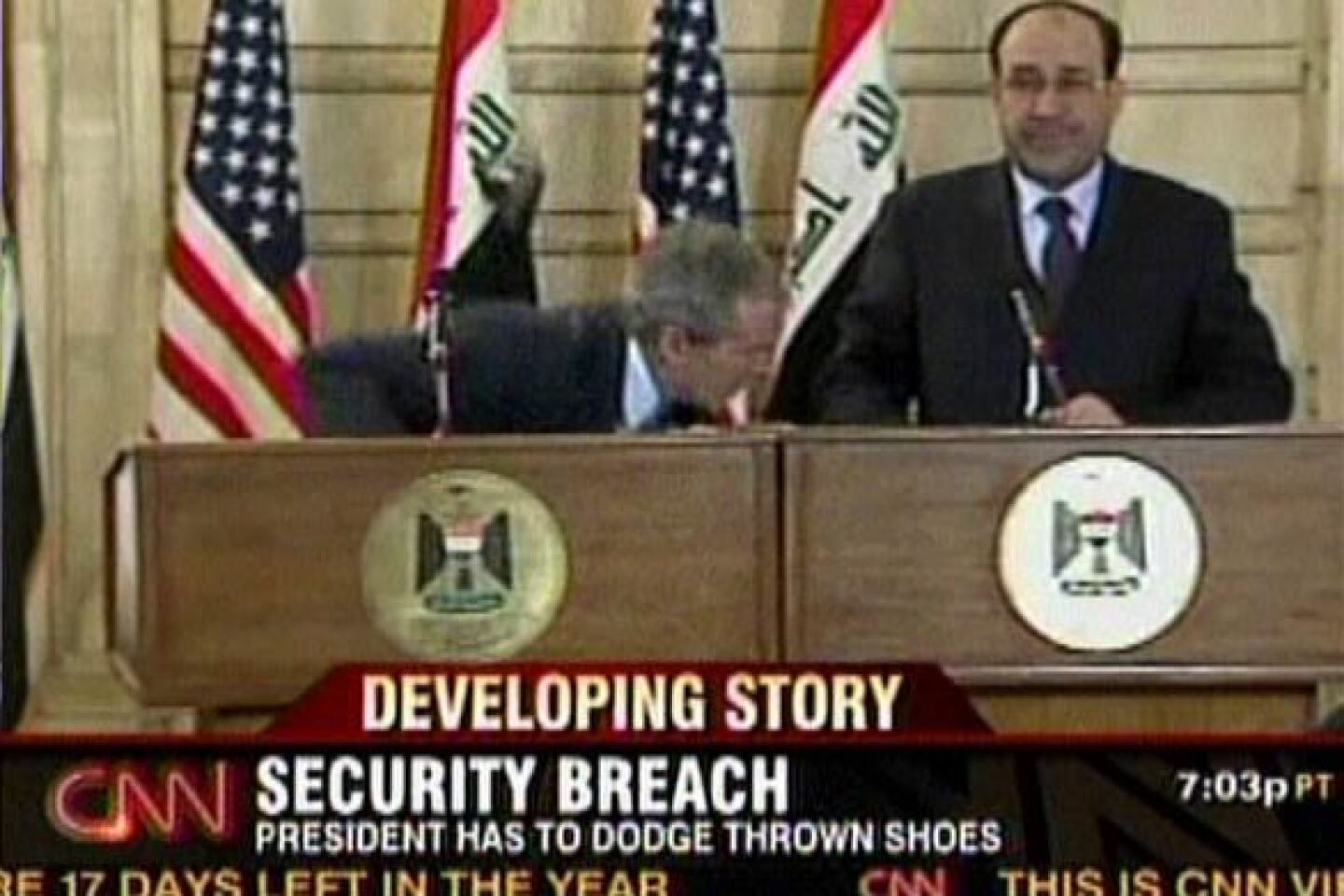 A screen grab from CNN shows President Bush ducking as a journalist hurled two shoes at him during a news conference with Prime Minister Nouri Maliki in Baghdad. "This is a gift from the Iraqis. This is the farewell kiss, you dog," Muntather Zaidi shouted at Bush as he threw his footwear. Neither shoe hit its target.