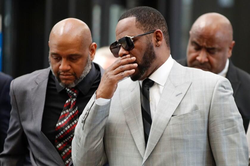 (FILES) In this file photo taken on June 6, 2019 Singer R. Kelly arrives for a court hearing at the Leighton Criminal Court Building in Chicago. - R. Kelly has been arrested on child pornography and other charges, the New York Times reported, in the latest criminal investigation into the R&B superstar dogged by allegations of sexual misconduct. The 52-year-old, whose legal name is Robert Kelly, was taken into custody by federal agents in Chicago late on July 11, 2019, the newspaper said. (Photo by KAMIL KRZACZYNSKI / AFP)KAMIL KRZACZYNSKI/AFP/Getty Images ** OUTS - ELSENT, FPG, CM - OUTS * NM, PH, VA if sourced by CT, LA or MoD **