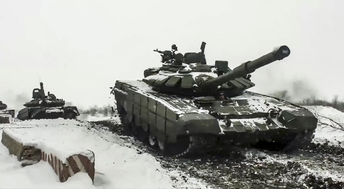 Russian tanks rolling over snowy ground