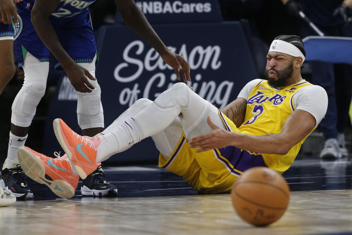 Lakers center Anthony Davis sustains a left knee sprain during a loss to the Minnesota Timberwolves on Friday night.