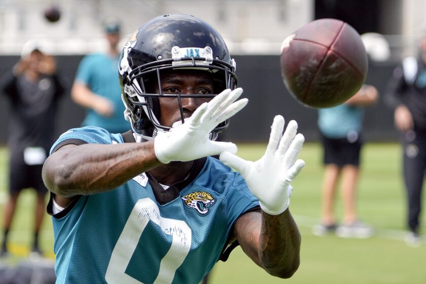 Jacksonville Jaguars wide receiver Calvin Ridley (0) catches a pass during an NFL football practice, Monday, June 5, 2023, in Jacksonville, Fla. (AP Photo/John Raoux)