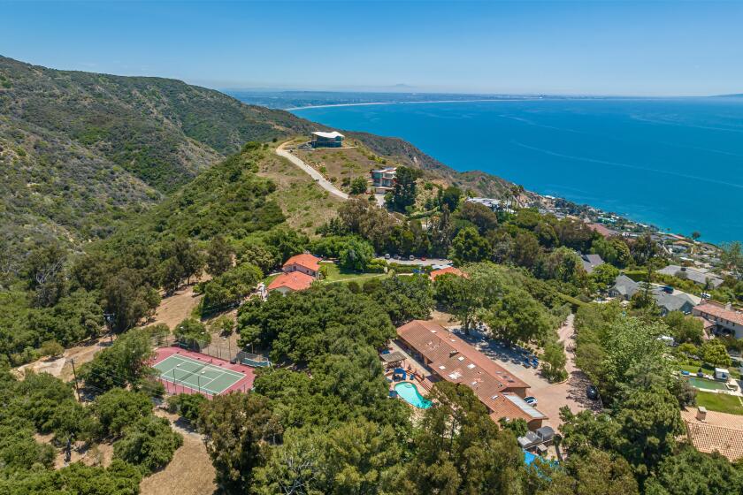 The three-acre property includes three homes, two swimming pools and a tennis court overlooking the ocean.