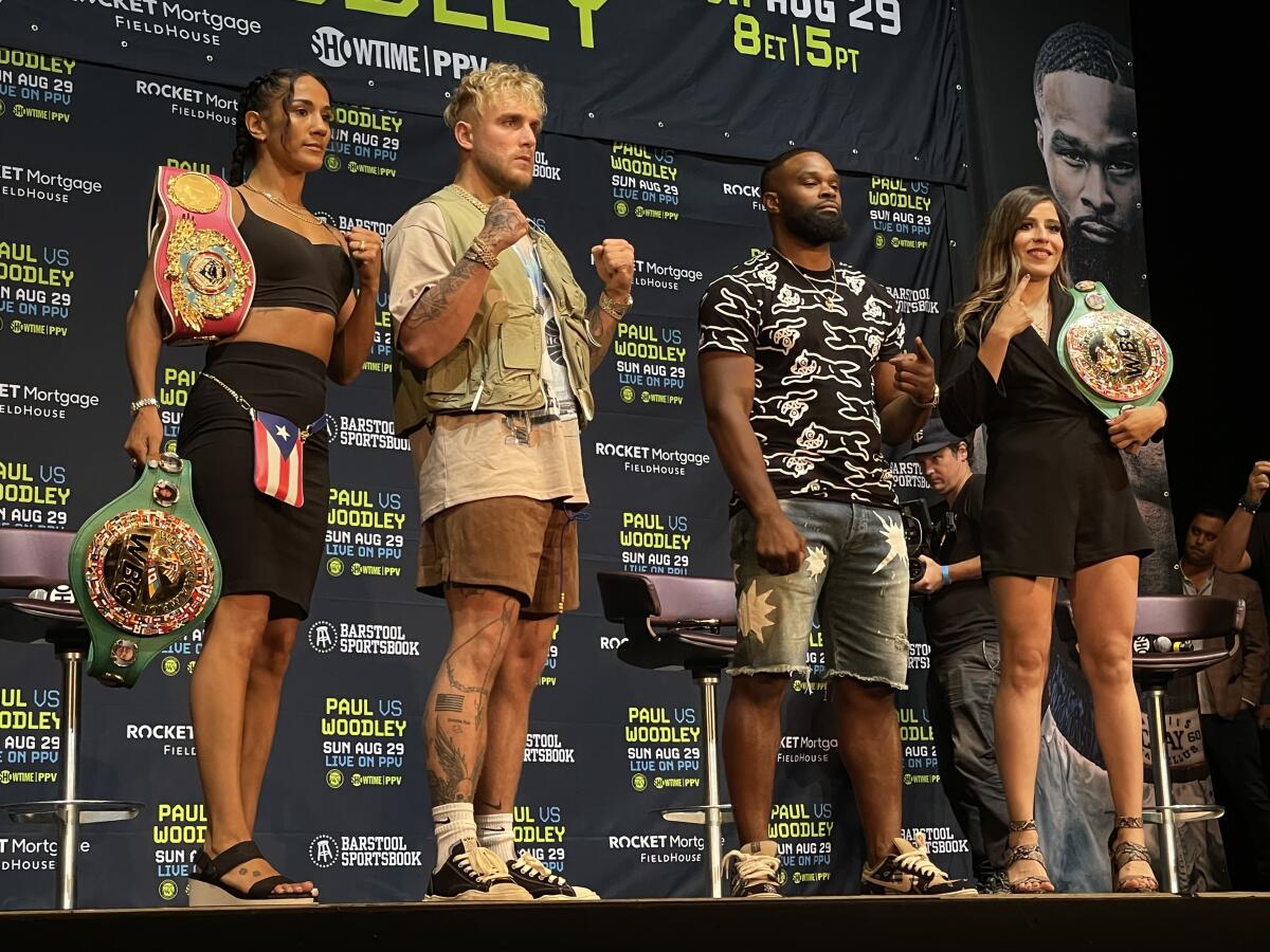 Amanda Serrano, Jake Paul, Tyron Woodley and Yamileth Mercado stand on the podium at The Novo after their news conference.