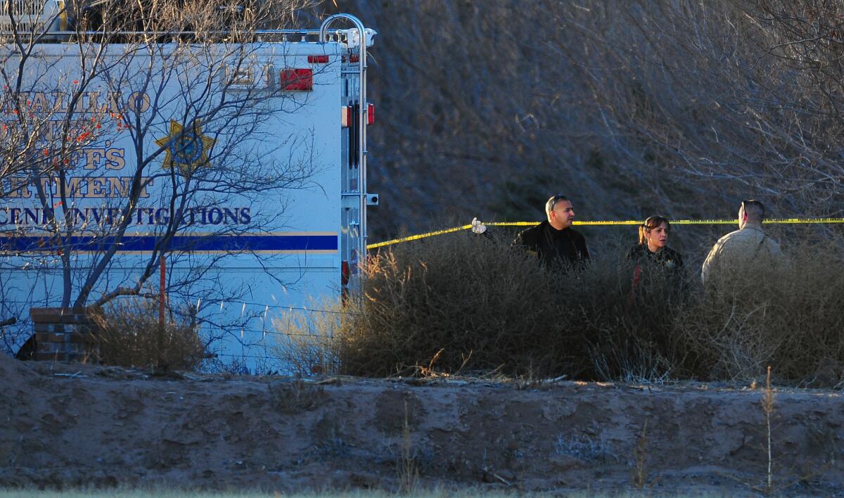 Bernalillo County sheriff's deputies investigate the scene of a multiple homicide in Albuquerque over the weekend. A 15-year-old boy confessed to shooting his parents and three young siblings, authorities said.