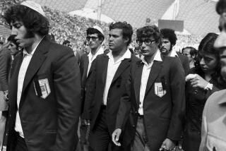 FILE - Members of Israel's Olympic team place black ribbons in their pockets after a memorial service mourning their comrades killed in Tuesday's Arab terrorists attack and subsequent police shoot-out leave the Olympic stadium in Munich, then West Germany, Wednesday, Sept. 6, 1972. The German government said Friday, April 21, 2023 it has set up an international commission of experts to review the events surrounding the 1972 attack on the Munich Olympics, a panel that was part of an agreement reached last year with relatives of the 11 Israeli athletes who were killed by Palestinian militants. (AP Photo, File)