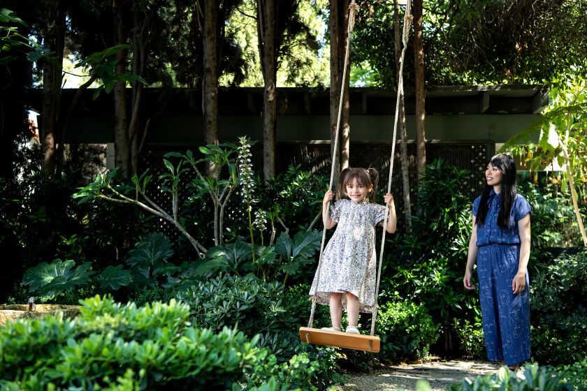 SAN MARINO, CA - MAY 25: Zara Robbins is pushed on the swing by her mom, Char, during a photoshoot in their backyard on Wednesday, May 25, 2022 in San Marino, CA. (Mariah Tauger / Los Angeles Times)