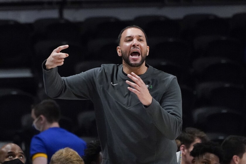 Minnesota head coach Ben Johnson gestures during the first half of the team's NCAA college basketball game against Pittsburgh, Tuesday, Nov. 30, 2021, in Pittsburgh. Minnesota won 54-53. (AP Photo/Keith Srakocic)