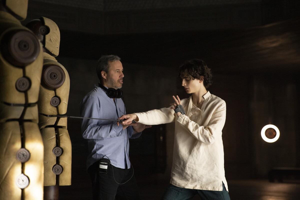 Director Denis Villeneuve, left, runs through a fight training scene with actor Timothée Chalamet on the set of "Dune."