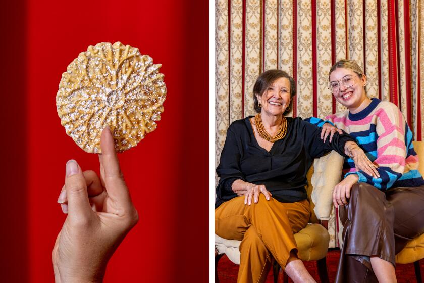 A thin and crispy Italian pizzelle cookie, left, from Lupe Del Rivo, right, pictured with her granddaughter Cici Del Rivo.