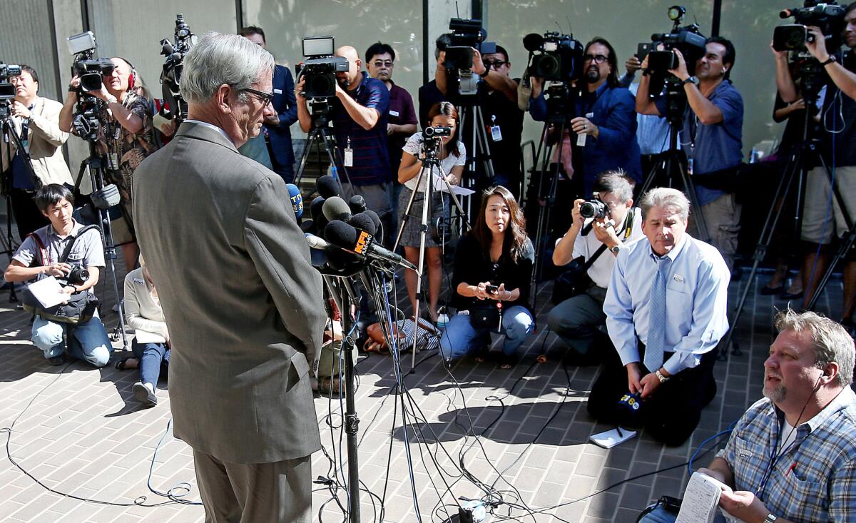 Dr. Robert Kim-Farley, left, director of communicable disease control and prevention for the Los Angeles County Department of Public Health, answers reporters' questions regarding Ebola during a news conference Wednesday in Alhambra.