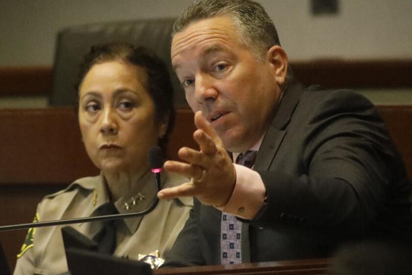 LOS ANGELES, CA - MARCH 26, 2019 - - Sheriff Alex Villanueva, right, addresses the issue of Secret Deputy Sub-groups as new Assistant Sheriff Robin Limon looks on during the Sheriff Civilian Oversight Commission at the Metropolitan Transit Authority in Los Angeles on March 26, 2019. "My job is to strike a careful balance," Villanueva said. ""Our job is public safety," he concluded. In a letter last week, the COC criticized Sheriff Villanueva, saying the department has engaged in "dissembling and stonewalling" when it comes to handing over documents related to cliques. The meeting comes at a time when Villanueva is facing criticism from several fronts, including from the Board of Supervisors, which went to court to try to stop him from reinstating a fired deputy. (Genaro Molina/Los Angeles Times)