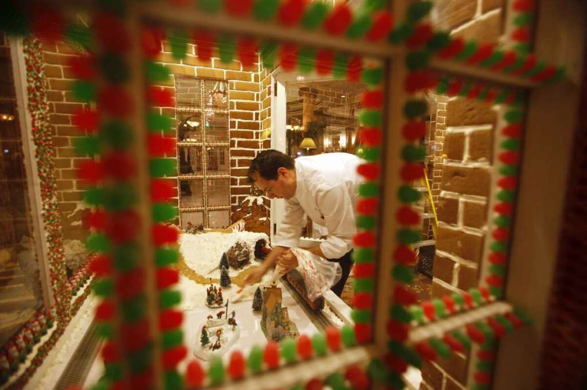 The Fairmont Hotel's executive sous chef Derek Ingraham labors over the hotel's 2009 gingerbread house. Since then it's gotten more elaborate, as has the holiday gingerbread house in the lobby of its rival, the St. Francis Hotel.