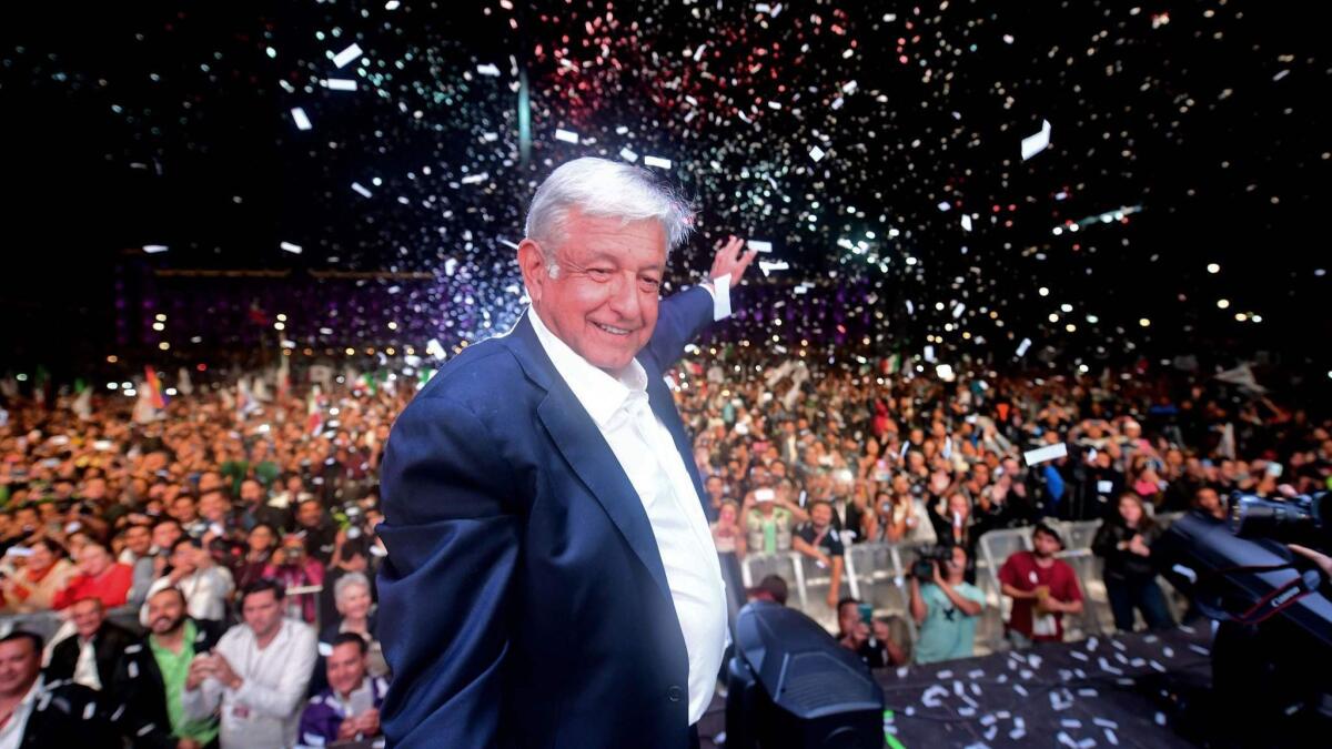 Andres Manuel Lopez Obrador cheers his supporters at the Zocalo square in Mexico City after Sunday's presidential election.