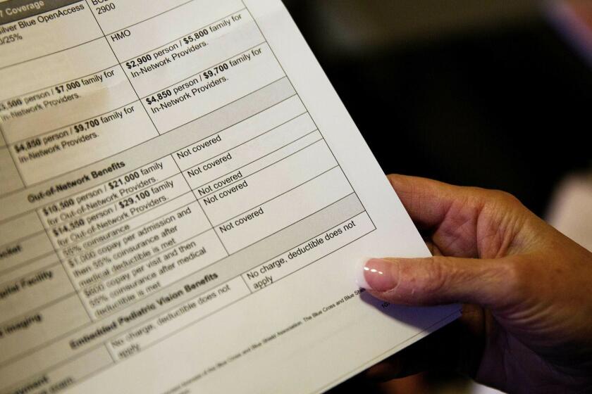 FILE - In this Monday, Dec. 4, 2017, file photo, a woman looks over her health insurance benefit comparison chart which shows out-of-network coverages dropped for 2018, at her home office in Peachtree City, Ga. Health insurers denied nearly 43 million claims in 2017 in part of the individual insurance market, and patients appealed well under 1% of those decisions, according to the nonprofit Kaiser Family Foundation, which analyzed data on care sought inside an insurers coverage network. (AP Photo/David Goldman, File)