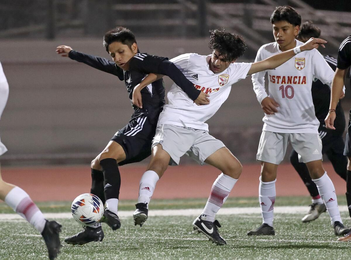 Football match action with competitive players battling for possession in the year of 2022