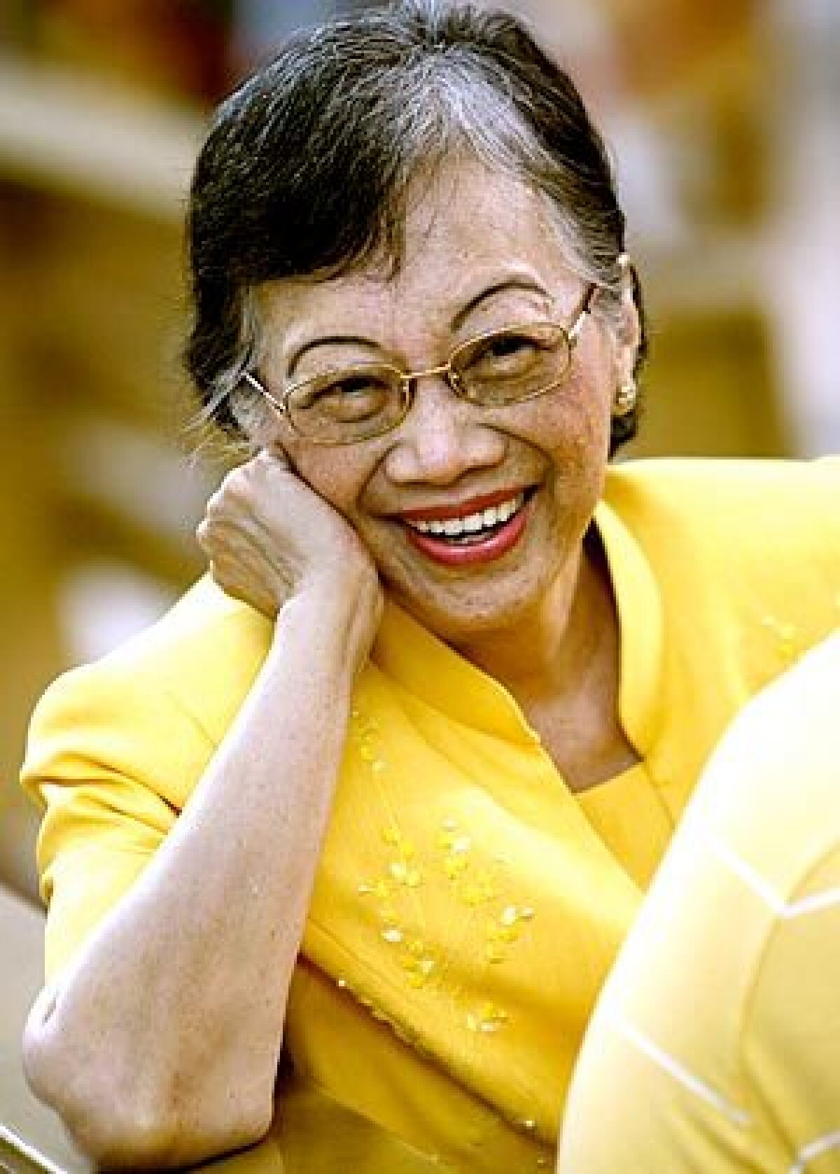 Aquino, in her signature yellow, attends Mass in 2008 to commemorate the 25th anniversary of her husband's slaying, which sparked a nonviolent uprising that toppled dictator Ferdinand Marcos and brought her to power.