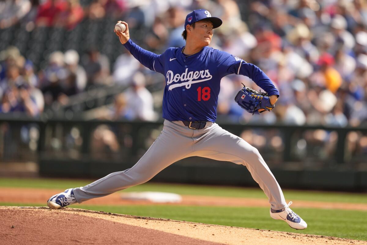 Dodgers starting pitcher Yoshinobu Yamamoto throws against the Rangers in his spring training debut on Wednesday.