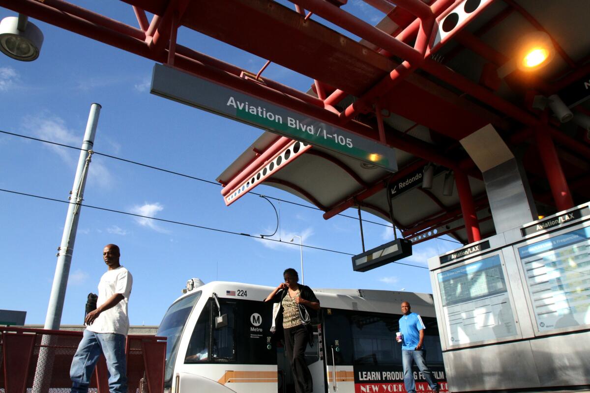 Commuters get off the Metro Green Line at the Aviation/LAX station. Reaching the airport requires boarding a shuttle bus for a 15-minute ride to the terminal area.
