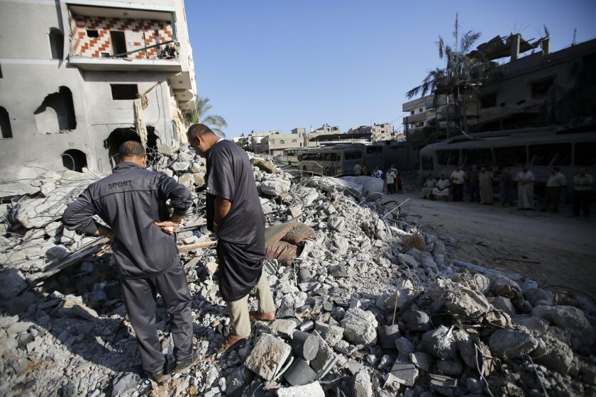 Palestinians inspect the rubble of a destroyed house in Gaza City's Sheikh Radwan neighborhood after an Israeli strike on Aug. 19.