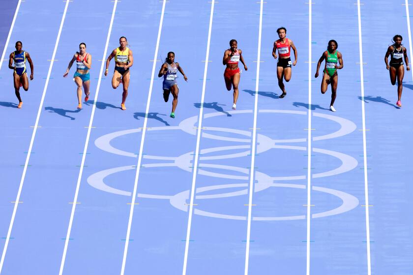 American Sha'carri Richardson, fourth from left, easily wins her women's 100-meter qualifying heat Friday in Paris.