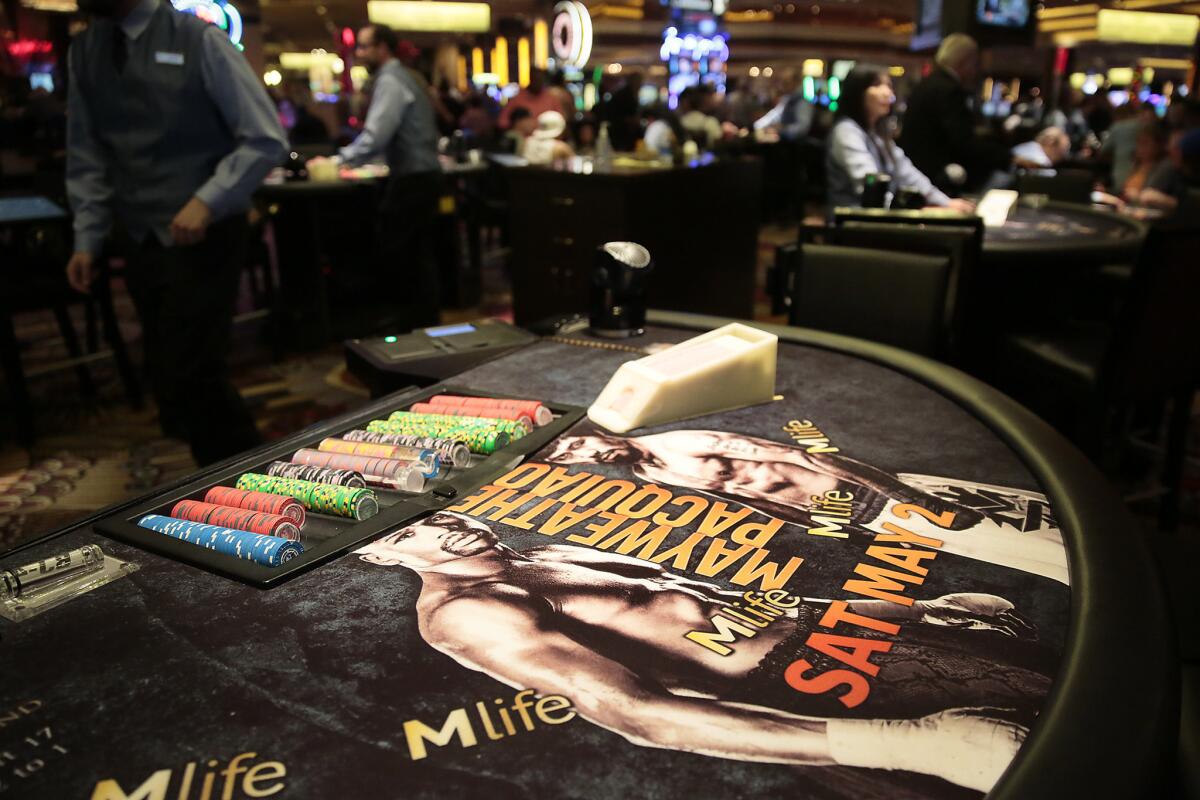 The MGM Grand gaming tables feature advertising for the welterweight title unification bout for Floyd Mayweather Jr. and Manny Pacquiao.