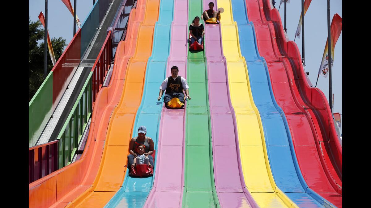 Riders go down the Euro Slide during opening day of the 2019 Orange County Fair in Costa Mesa on July 13.
