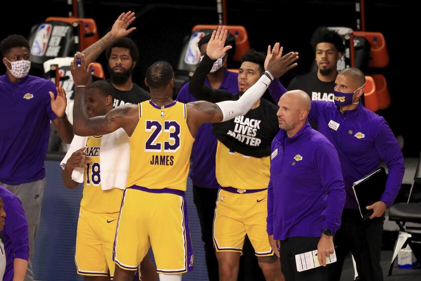 Los Angeles Lakers' LeBron James (23) celebrates with his teammates after they defeated the Los Angeles Clippers in an NBA basketball game Thursday, July 30, 2020, in Lake Buena Vista, Fla. (Mike Ehrmann/Pool Photo via AP)