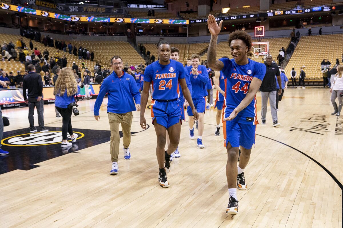 Florida's Niels Lane, right, celebrates as he walks off the court after beating Missouri 66-65 in an NCAA college basketball game Wednesday, Feb. 2, 2022, in Columbia, Mo. (AP Photo/L.G. Patterson)