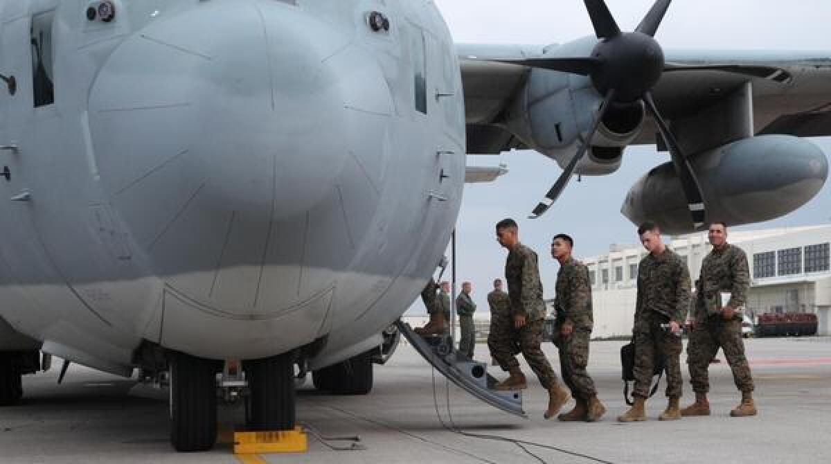 U.S. Marines board a KC-130J Hercules aircraft at Marine Corps Air Station Futenma on the Japanese island of Okinawa on Monday in preparation for a relief mission to the Philippines.