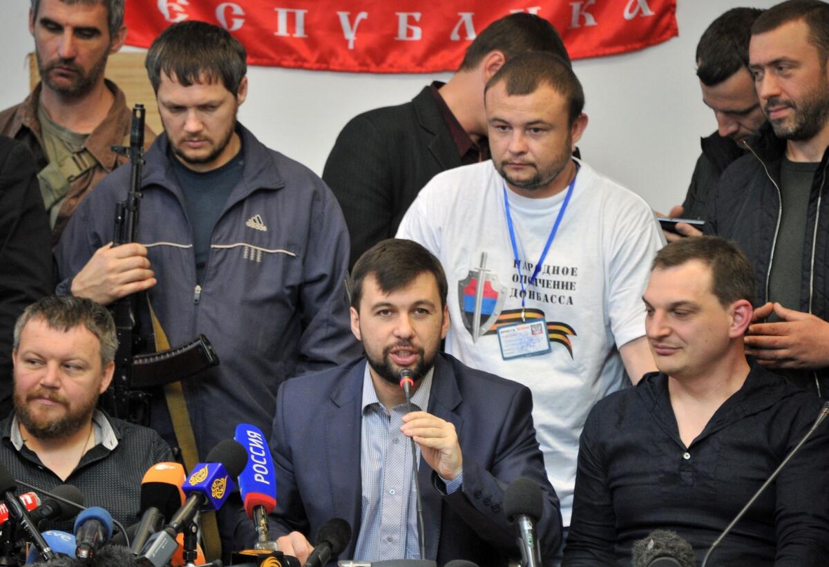 Denis Pushilin, at the microphone, told reporters in Donetsk on Thursday that separatists in the eastern Ukrainian region have rejected Russian President Vladimir Putin's "respected" advice to postpone a Sunday referendum on secession from Ukraine.
